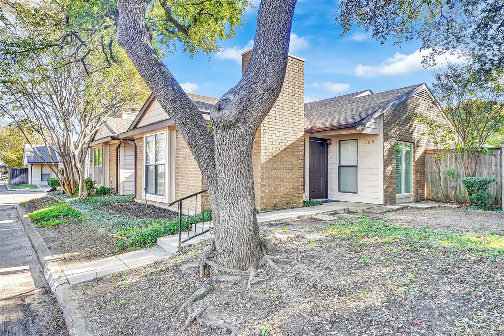 2111 East Belt Line Road, Unit 166B Richardson, TX 75081 - Photo 3 of 23 View of front facade featuring brick siding and a shingled roof