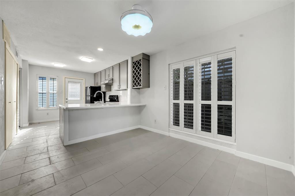 2111 East Belt Line Road, Unit 166B Richardson, TX 75081 - Photo 10 of 23 Kitchen with light countertops, gray cabinetry, a peninsula, freestanding refrigerator, and recessed lighting