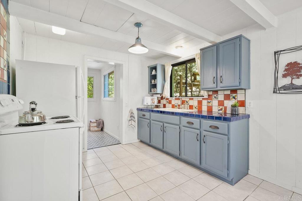 3055 Pera Alta Drive Julian, CA 92036 - Photo 18 of 44 a kitchen with granite countertop a sink and cabinets