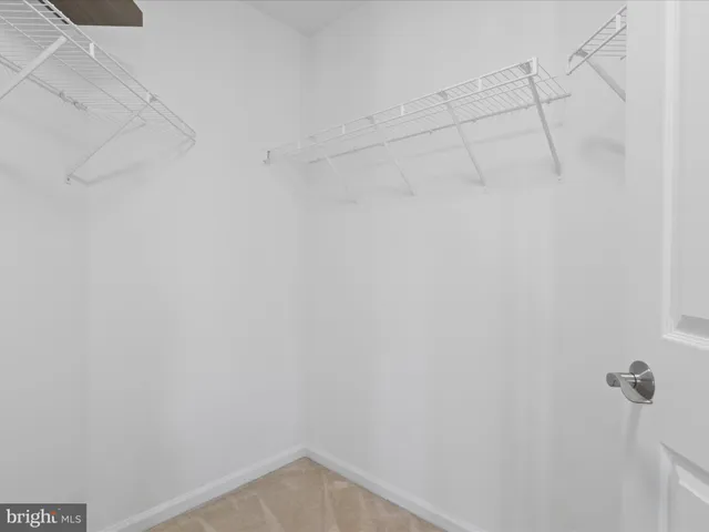 a bathroom with a toilet a sink a mirror and vanity