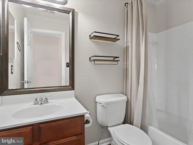 a front view of a house with a parking space