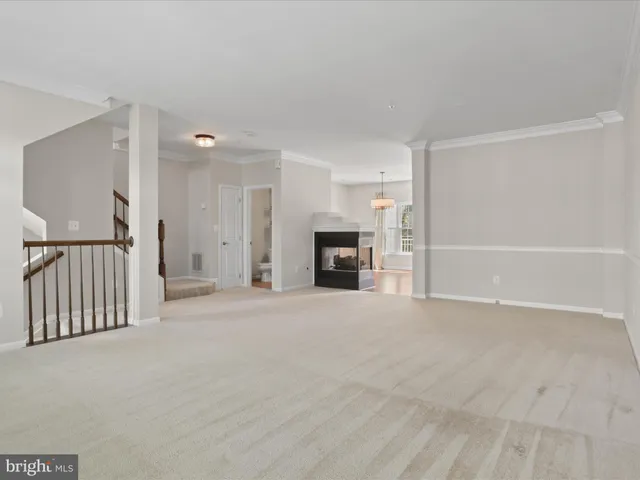 a view of an empty room with a fireplace