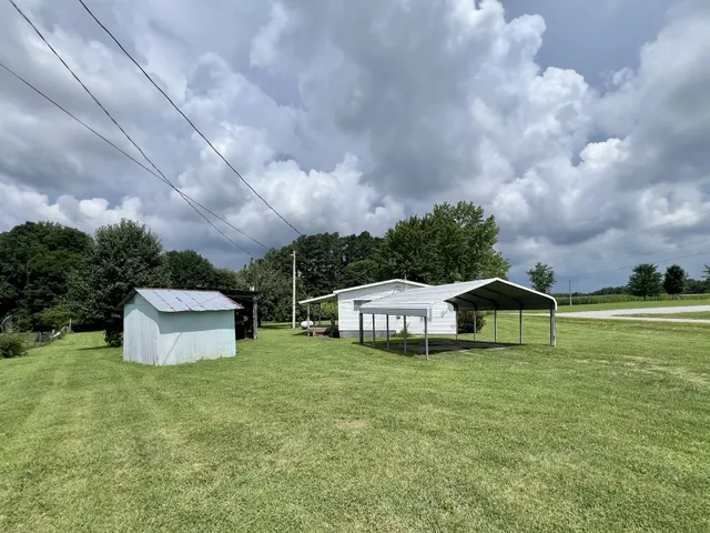 a aerial view of a house with swimming pool and green space