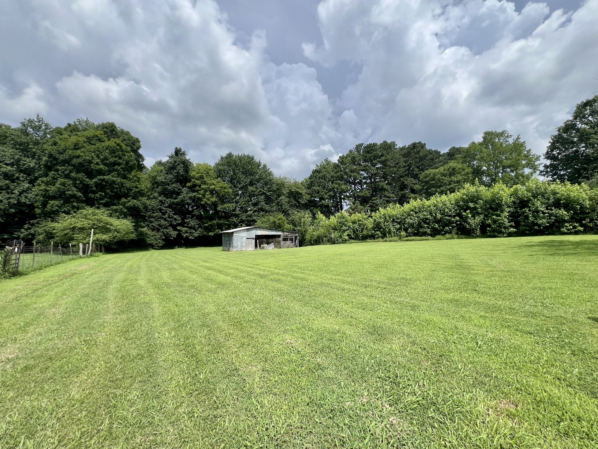 3467 Fall River Road Pulaski, TN 38478 - Photo 2 of 38 a view of a green field with wooden fence