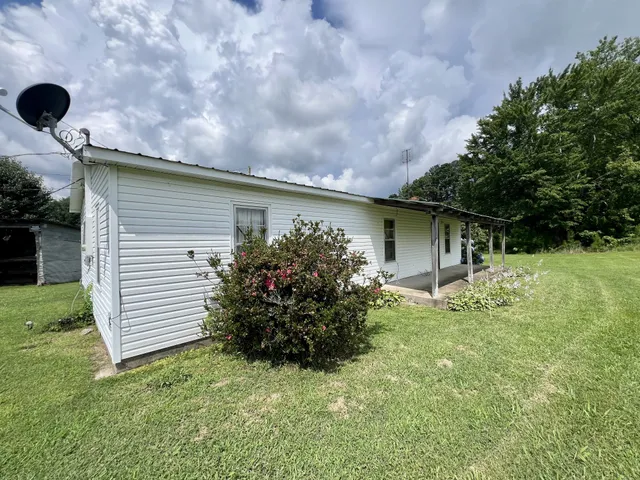 a backyard of a house with plants and garden