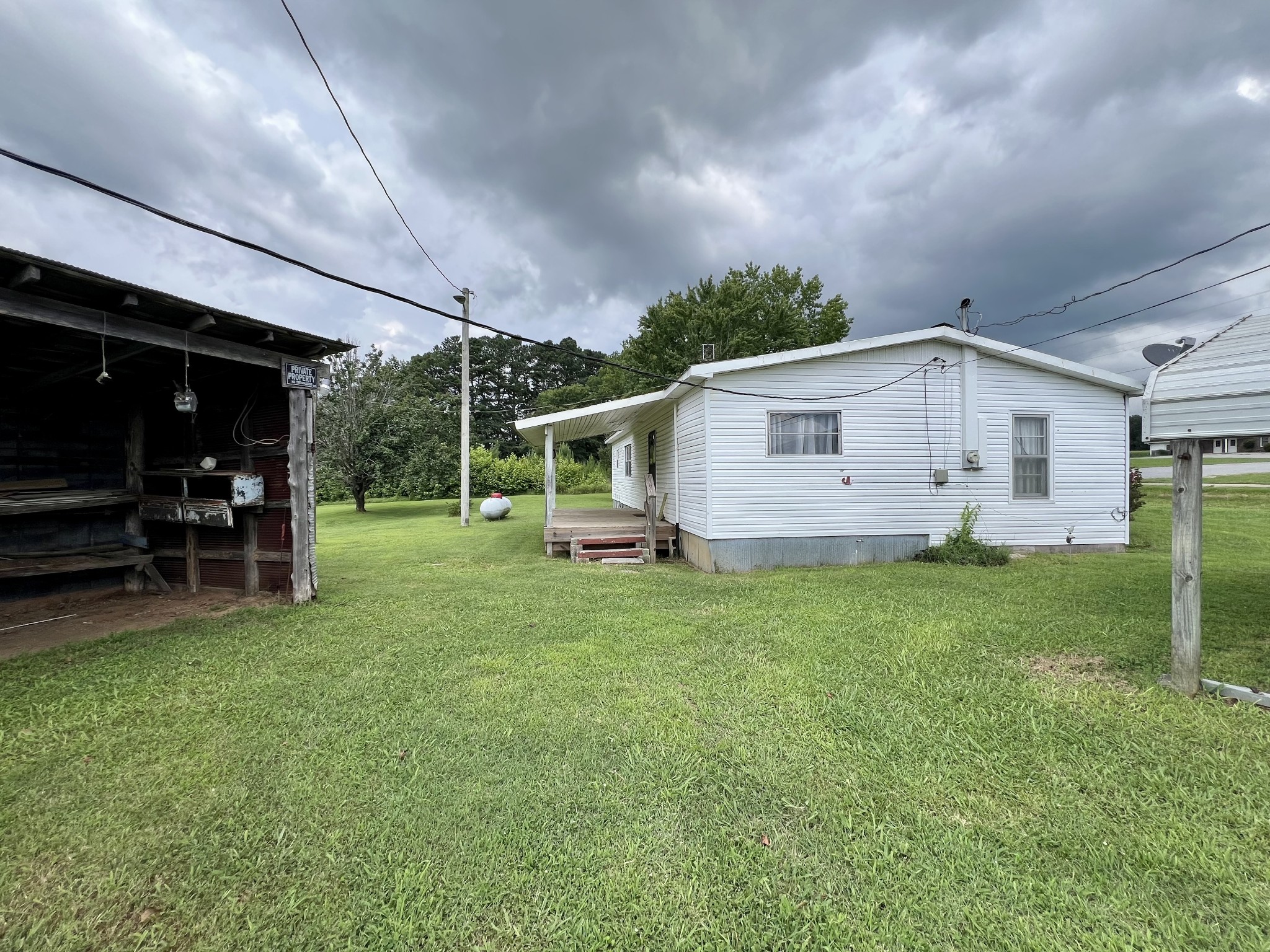 3467 Fall River Road Pulaski, TN 38478 - Photo 24 of 38 a view of a backyard with table and chairs and potted plants