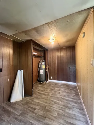 an empty room with closet and windows