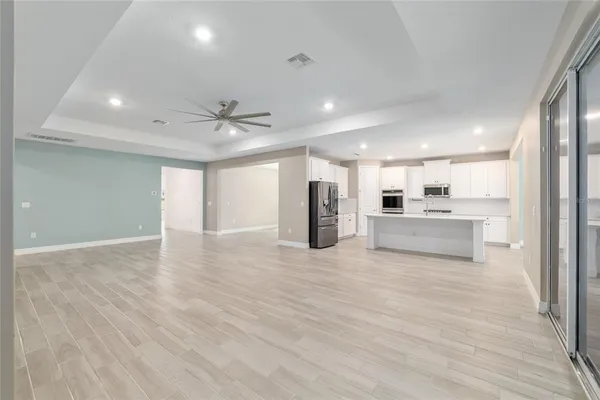 a view of kitchen with wooden floor and refrigerator