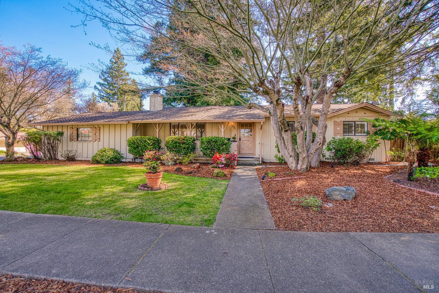 2990 Brookwood Drive Napa, CA 94558 - Photo 1 of 1 a front view of a house with garden and trees