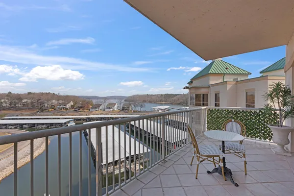 a balcony with table and chairs