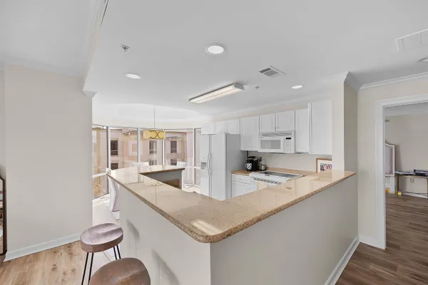 a kitchen with stainless steel appliances granite countertop a sink and a refrigerator
