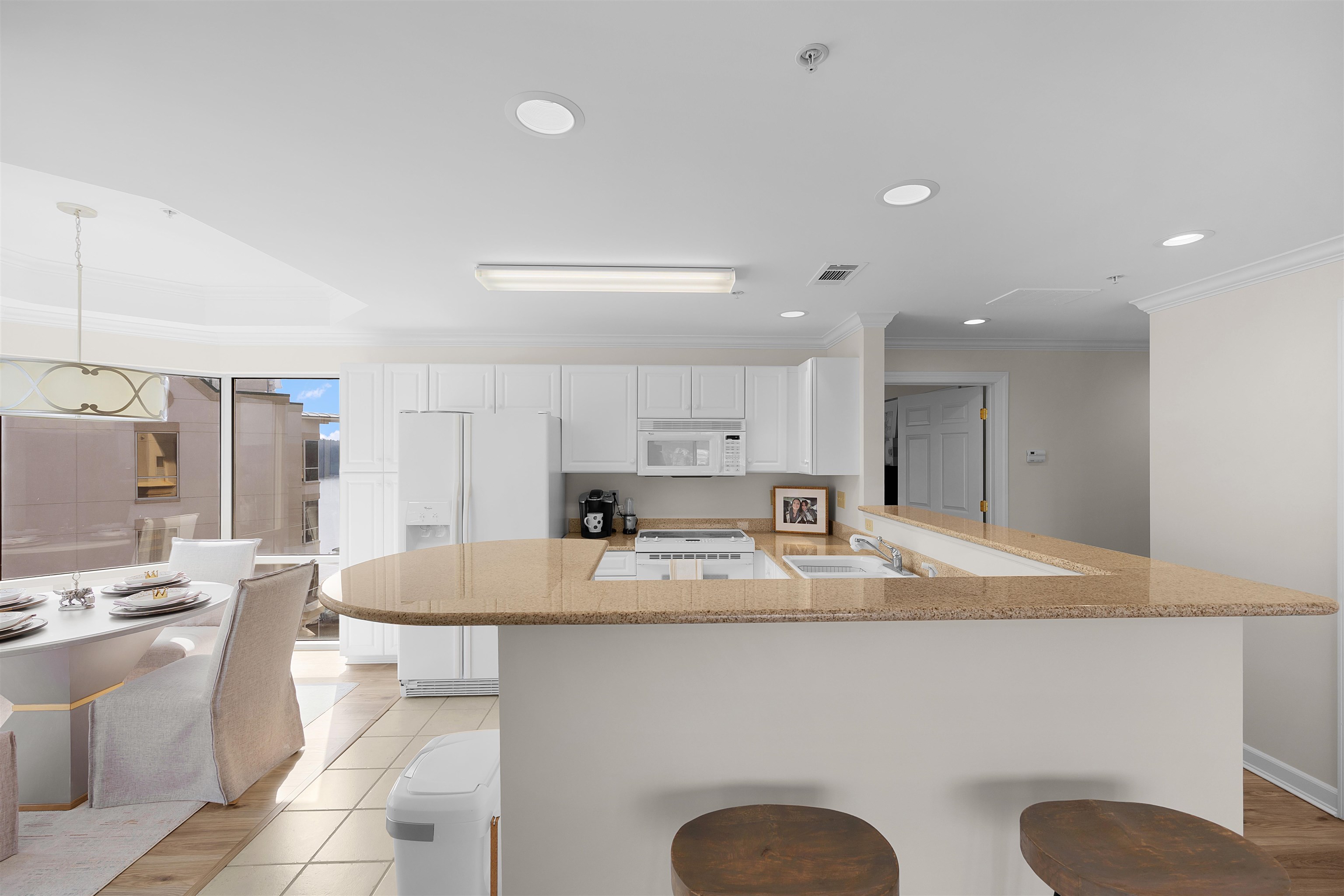 323 Cr 380 Road, Unit P 605 Iuka, MS 38852 - Photo 6 of 24 a large kitchen with kitchen island granite countertop a sink a stove a dining table and chairs