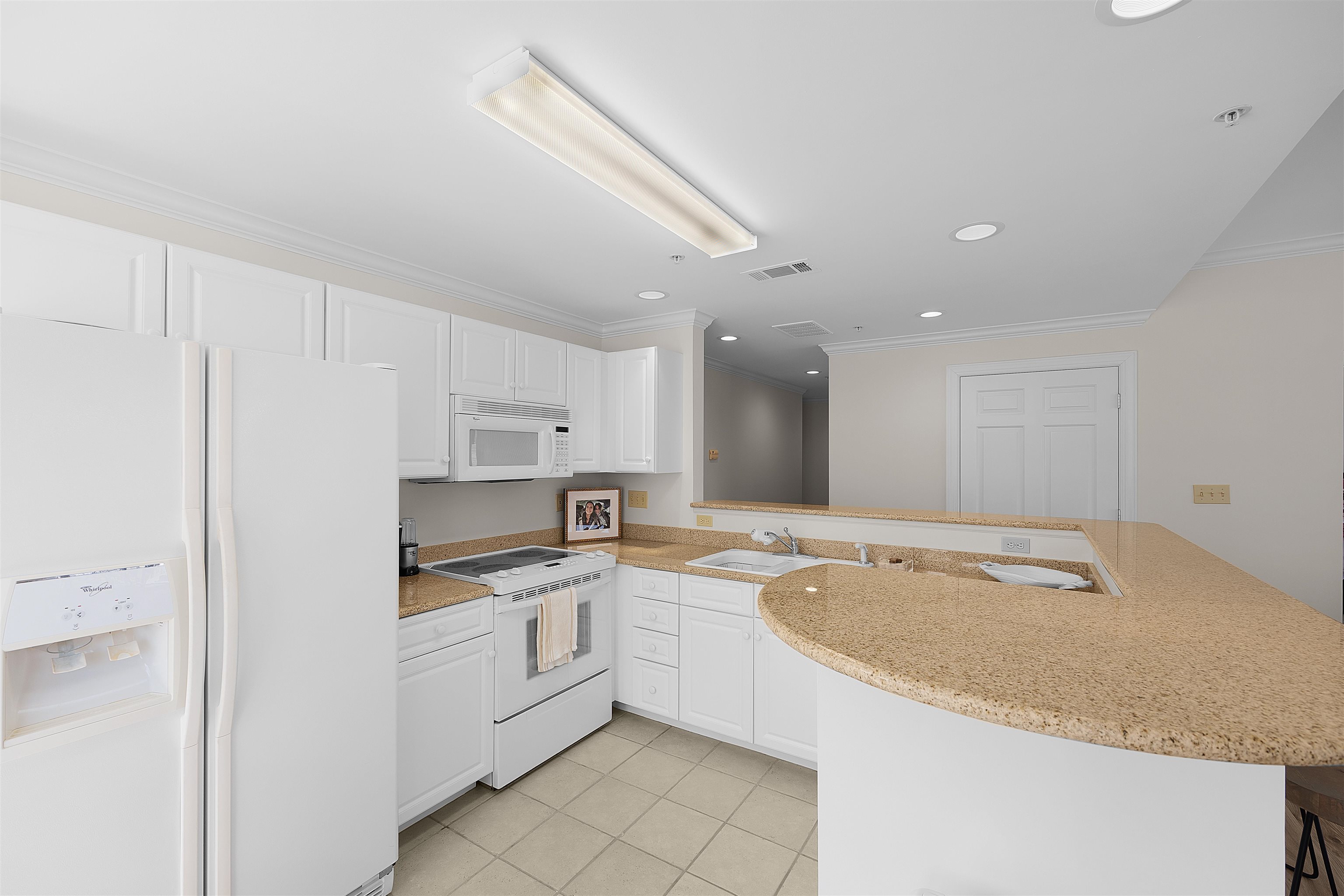 323 Cr 380 Road, Unit P 605 Iuka, MS 38852 - Photo 8 of 24 a large white kitchen with a sink dishwasher stove and white cabinets