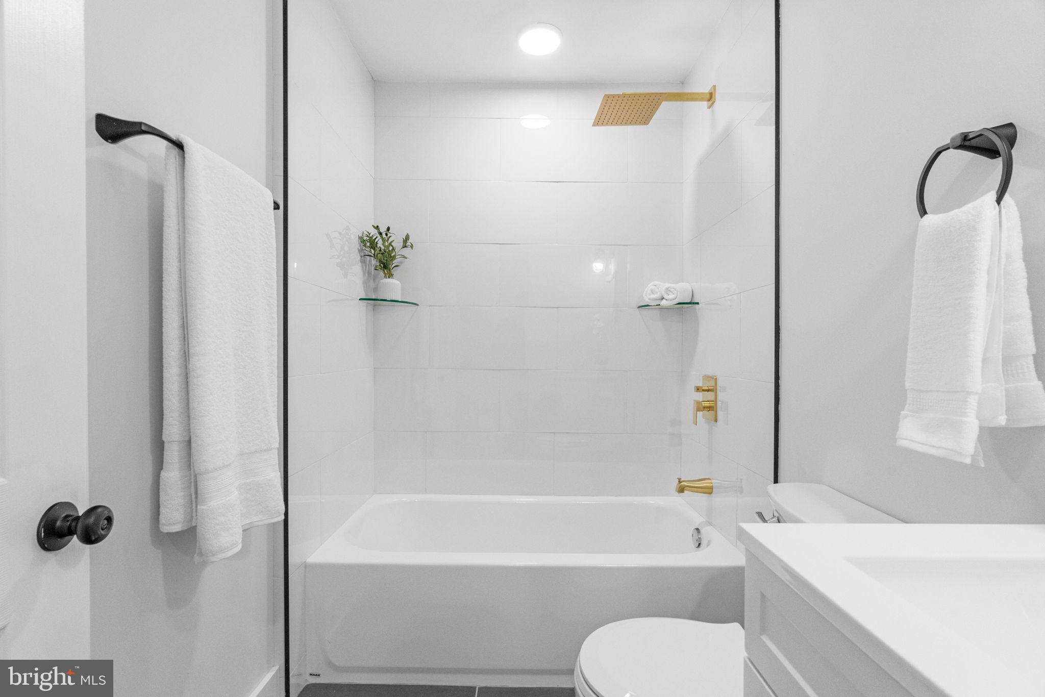 4233 Passmore Street Philadelphia, PA 19135 - Photo 15 of 30 a bathroom with a shower bathtub and a toilet