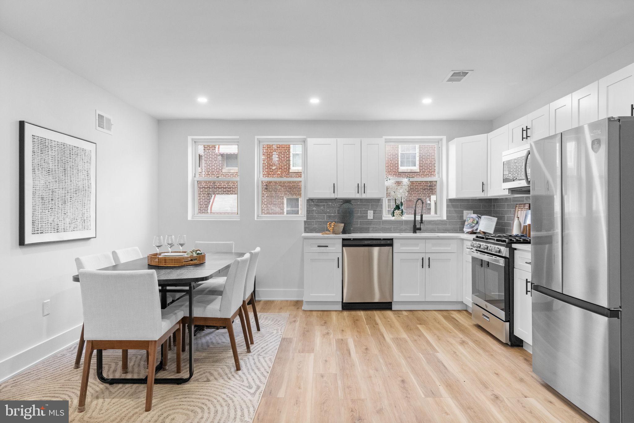 4233 Passmore Street Philadelphia, PA 19135 - Photo 6 of 30 a kitchen with a refrigerator a table and chairs in it