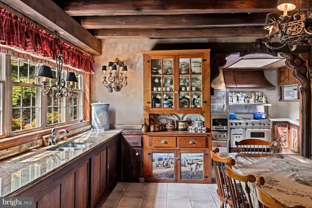a kitchen with stainless steel appliances granite countertop a stove and a sink