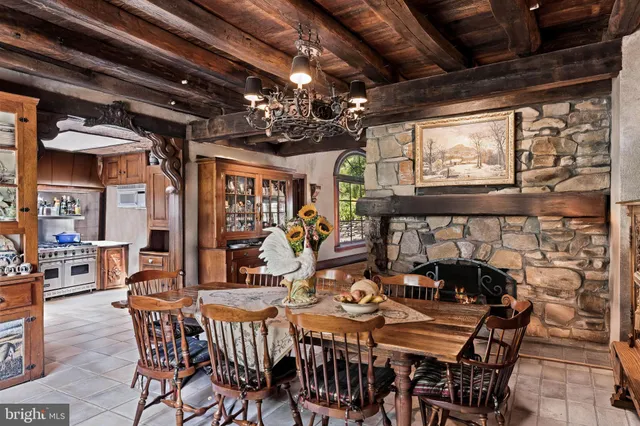 a view of a dining room with furniture a chandelier and fireplace