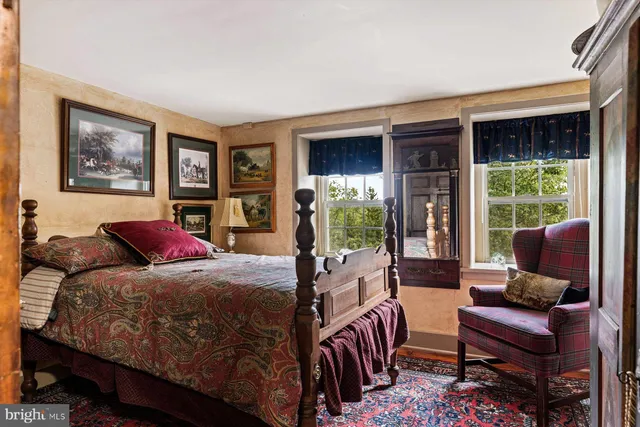 a bedroom with a large bed and a large window