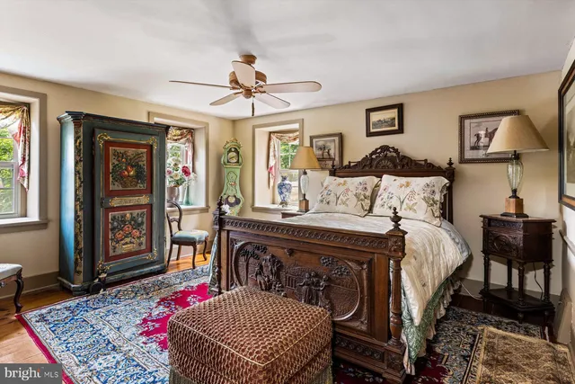 a bedroom with a bed a dresser and chair