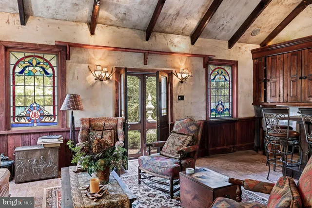 a living room filled with furniture and a window