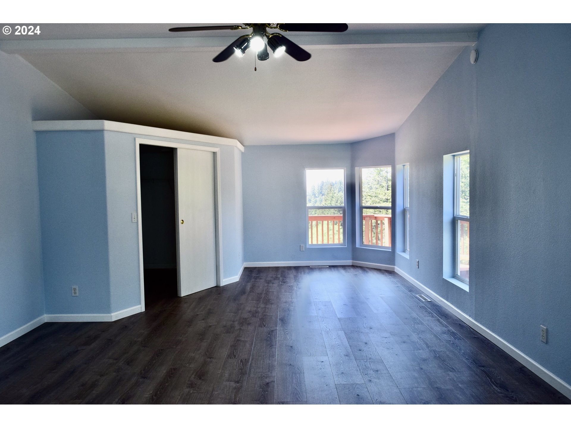27286 Eighty Acres Road Gold Beach, OR 97444 - Photo 12 of 46 a view of an empty room with window and wooden floor
