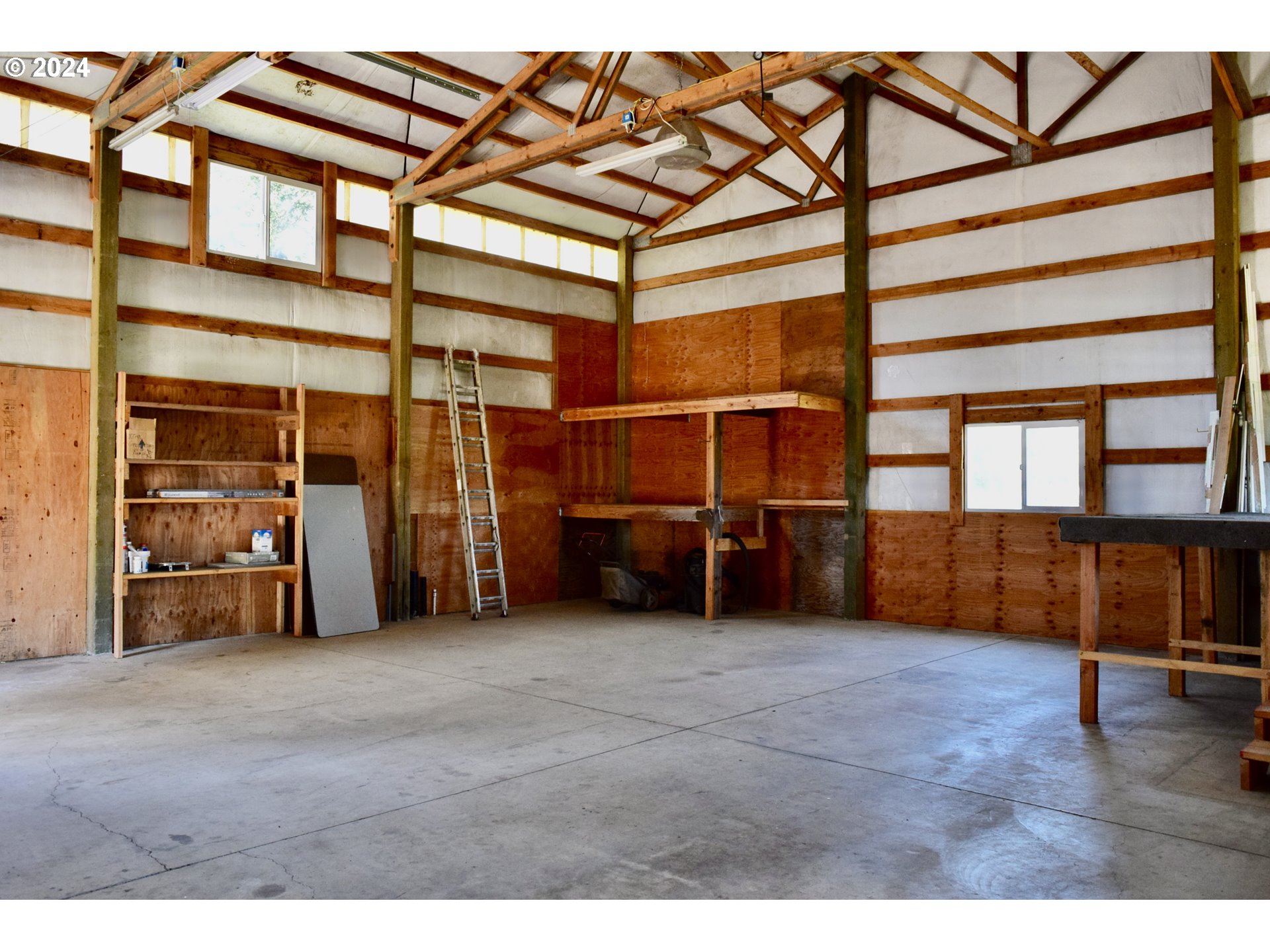 27286 Eighty Acres Road Gold Beach, OR 97444 - Photo 23 of 46 a view of an empty room with wooden floor and a window