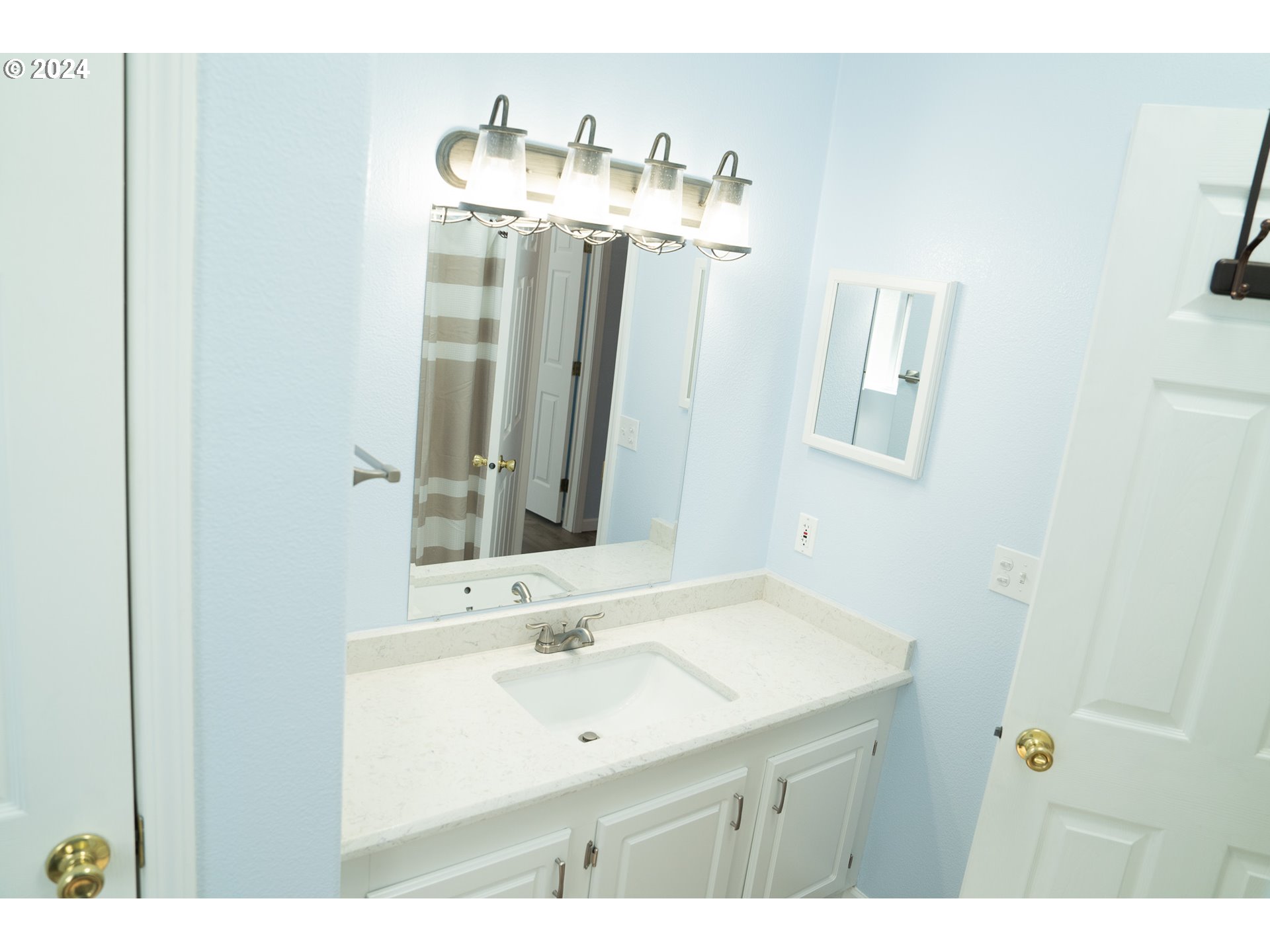 27286 Eighty Acres Road Gold Beach, OR 97444 - Photo 38 of 46 a bathroom with a sink vanity and a mirror