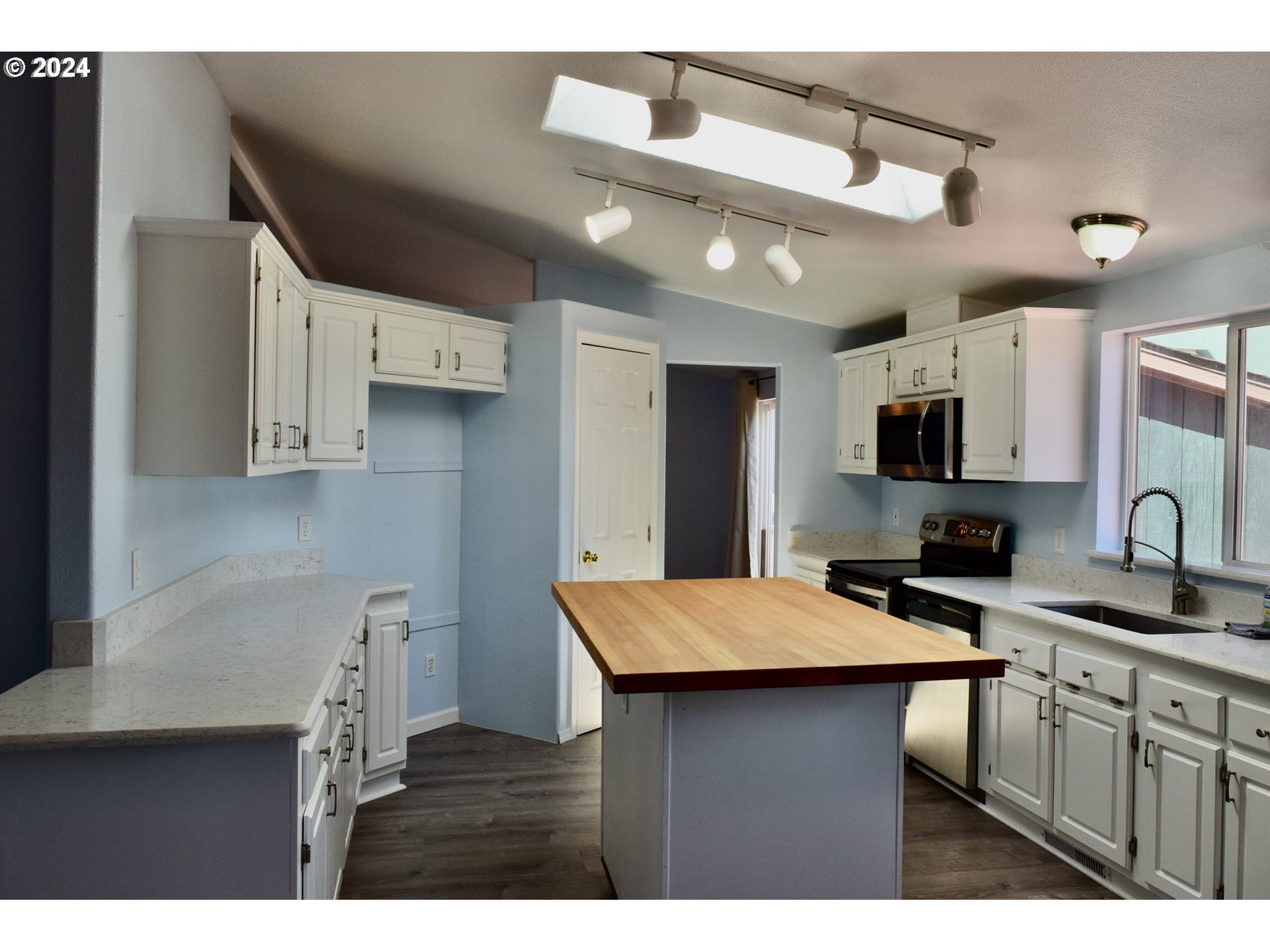 27286 Eighty Acres Road Gold Beach, OR 97444 - Photo 5 of 46 a kitchen with cabinets and wooden floor