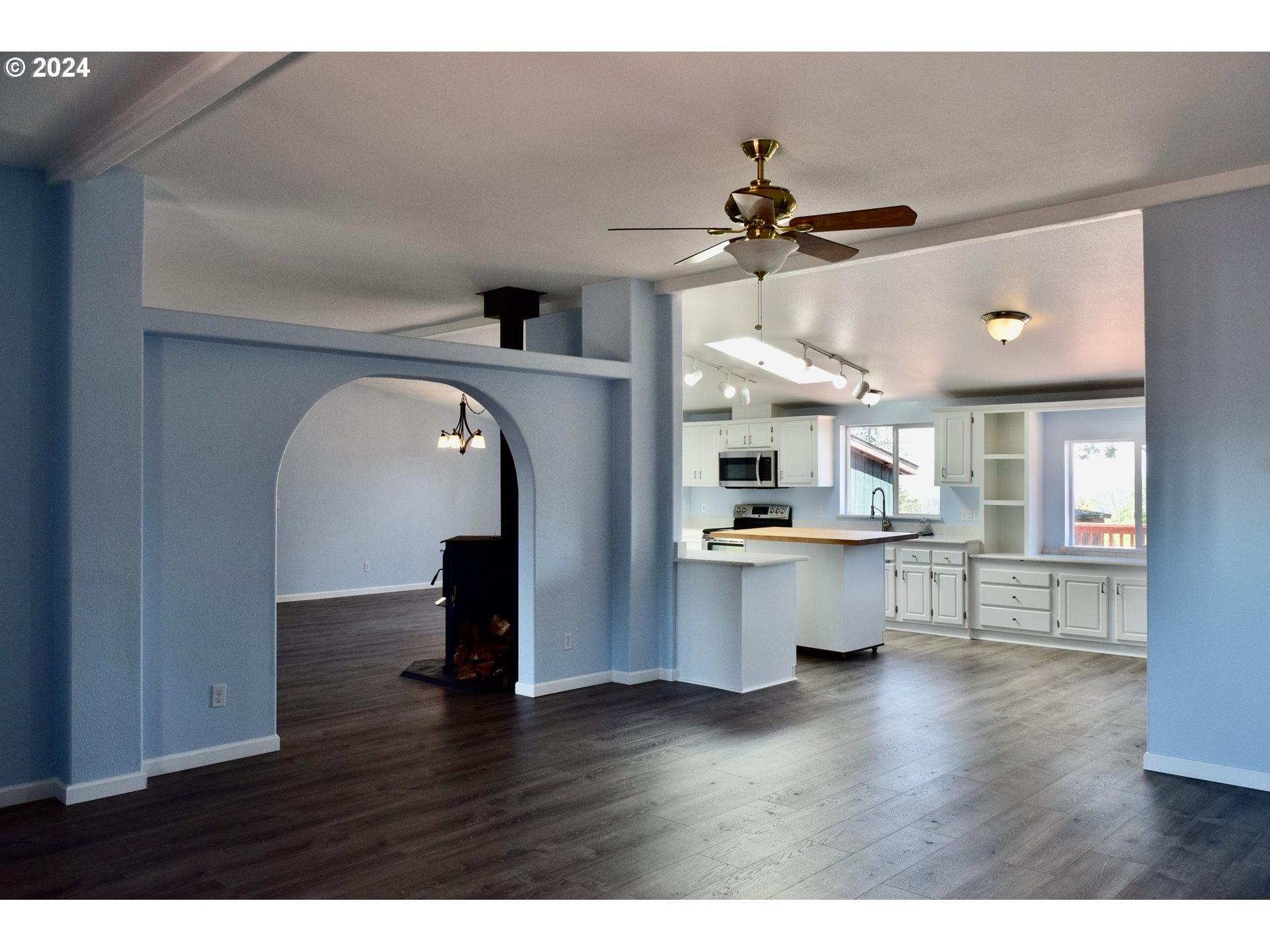 27286 Eighty Acres Road Gold Beach, OR 97444 - Photo 6 of 46 a view of a living room with kitchen and wooden floor