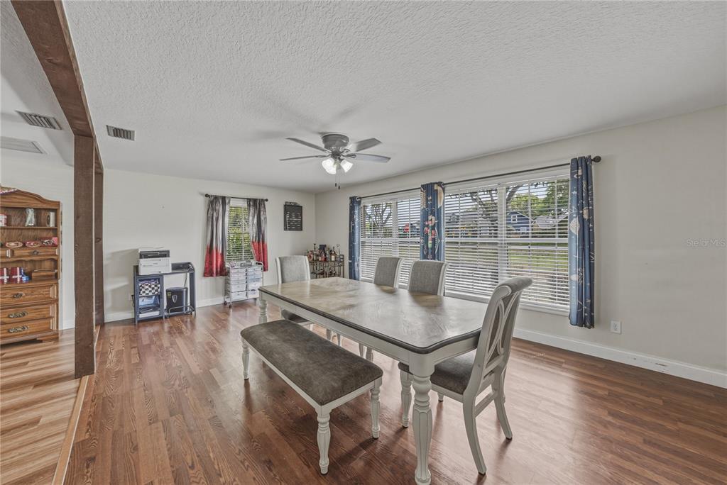 609 West Pipkin Road Lakeland, FL 33813 - Photo 25 of 72 a view of a dining room with furniture and wooden floor