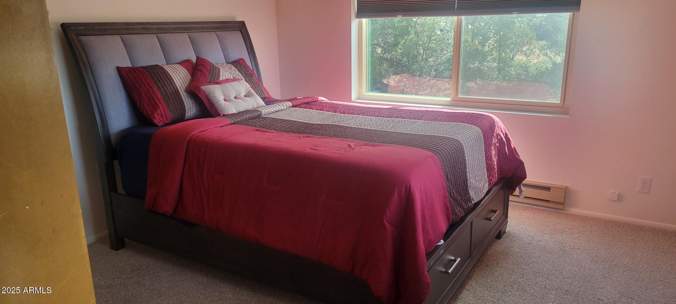 1285 Spruce Street Eagar, AZ 85925 - Photo 11 of 17 a bed sitting in a bedroom next to a window