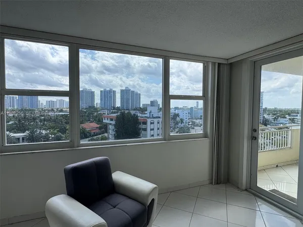 a view of a room with furniture and a large window