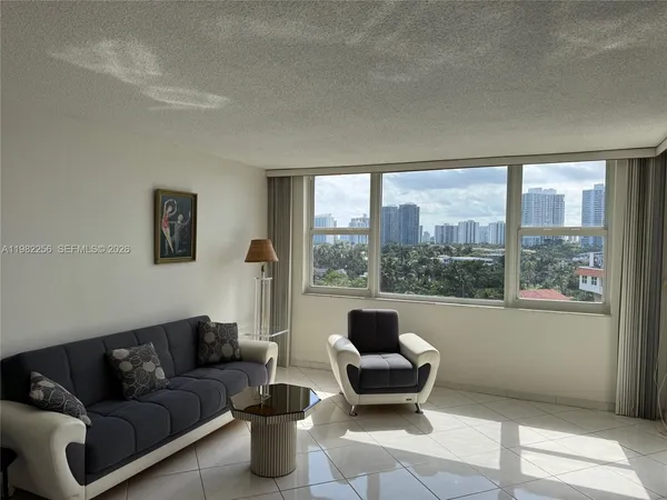 a living room with furniture and a floor to ceiling window