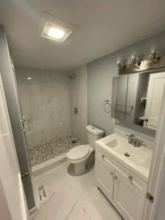 a bathroom with a sink toilet and shower