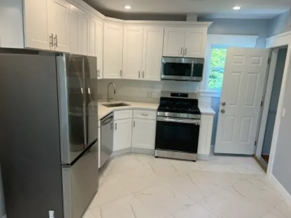a kitchen with a refrigerator stove and microwave