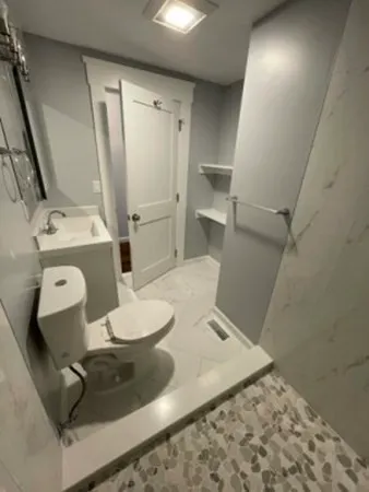 a bathroom with a sink toilet and shower