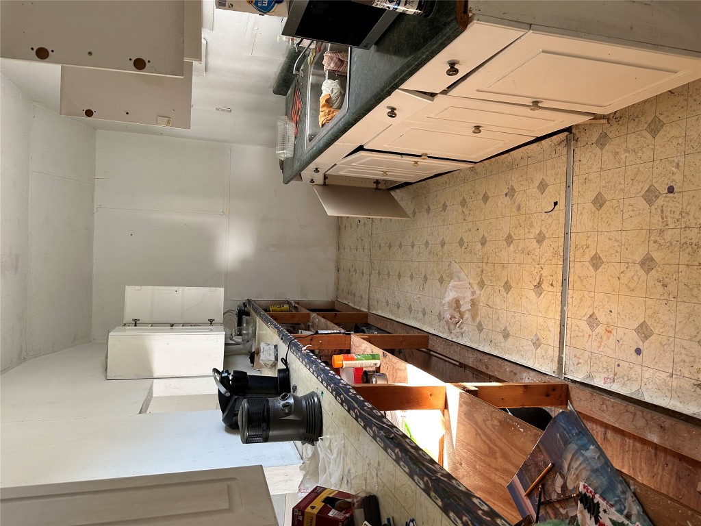 125 2nd Avenue Taylor, TX 76574 - Photo 5 of 9 a kitchen with stainless steel appliances granite countertop a stove and a sink