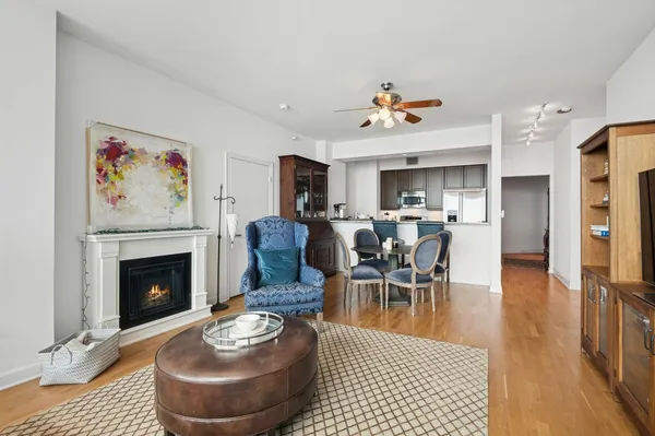a living room with furniture a fireplace and a table