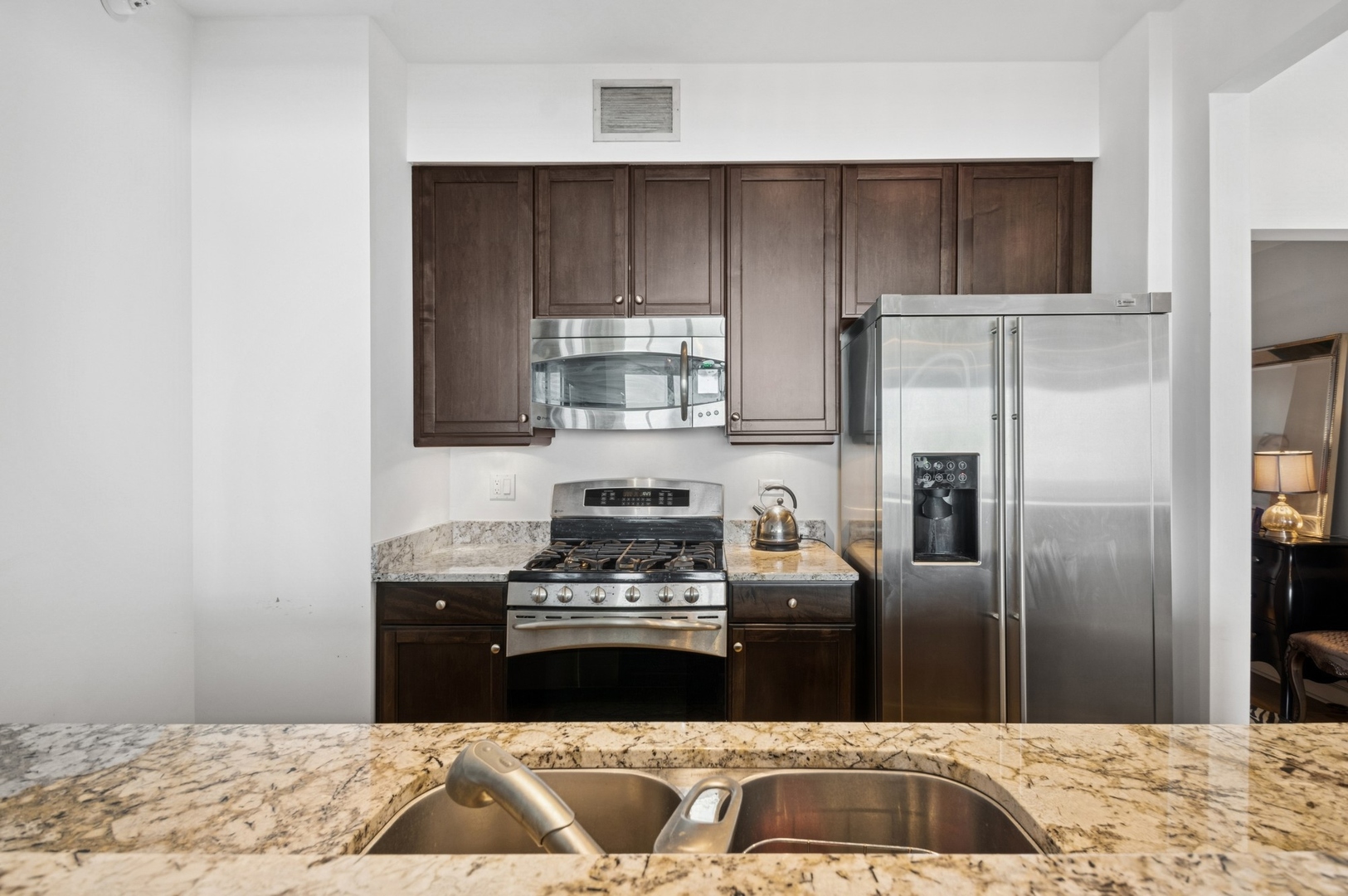 1201 South Prairie Avenue, Unit 4204 Chicago, IL 60605 - Photo 5 of 19 a kitchen with granite countertop a refrigerator stove and oven