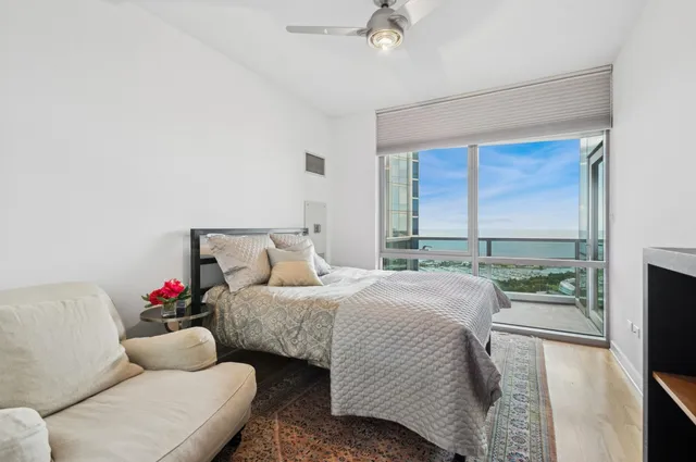 a bedroom with a bed dresser and a window