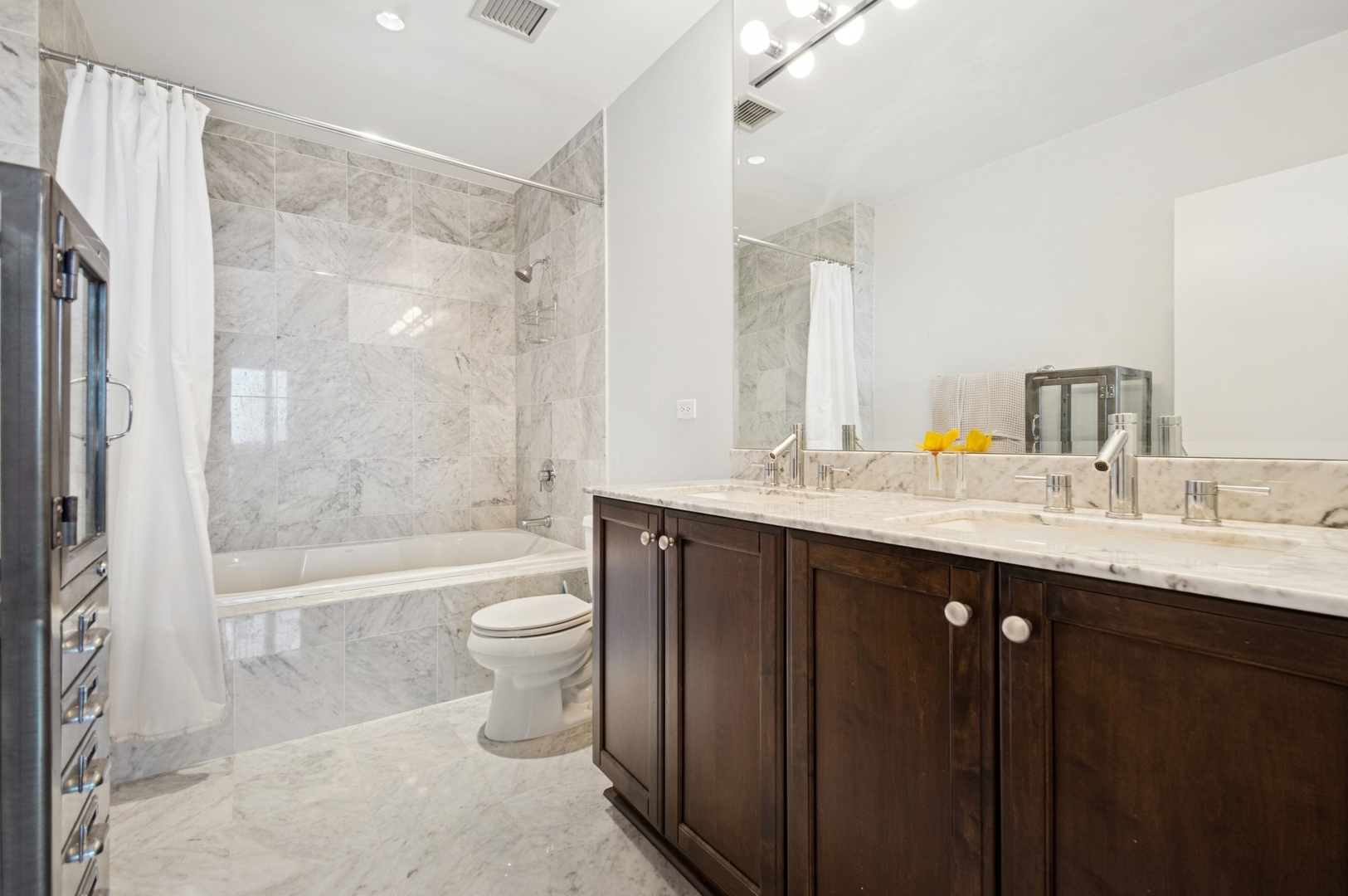 1201 South Prairie Avenue, Unit 4204 Chicago, IL 60605 - Photo 9 of 19 a bathroom with a double vanity sink toilet and shower