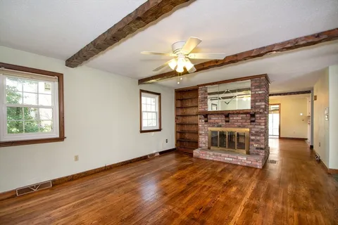 wooden floor in an empty room with a window