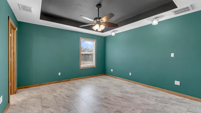 a view of a room with window and ceiling fan
