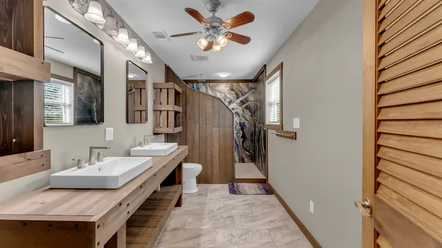 a living room with furniture and a ceiling fan
