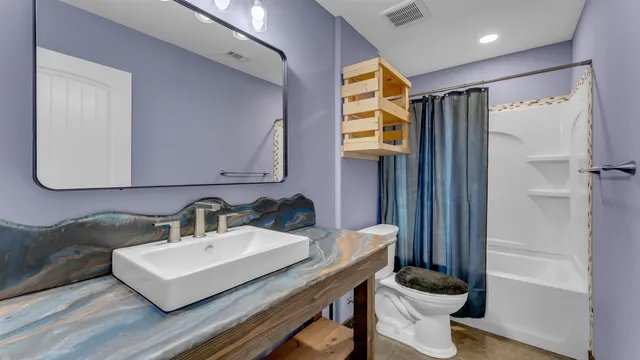 a bathroom with a sink a mirror and a toilet