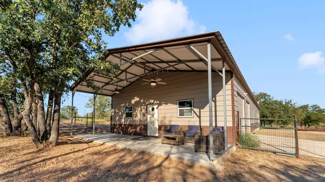 a view of a house with wooden fence