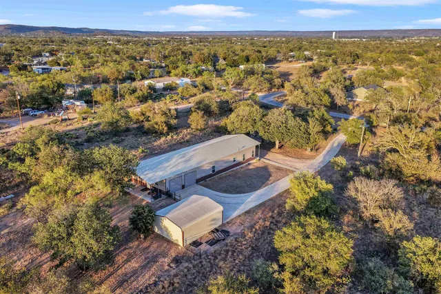 an aerial view of a house with a yard