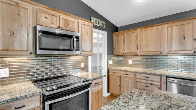 a kitchen with stainless steel appliances a stove sink and microwave
