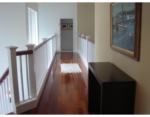 2 Links Road Gloucester, MA 01930 - Photo 5 of 7 a view of a hallway with wooden floor and stairs