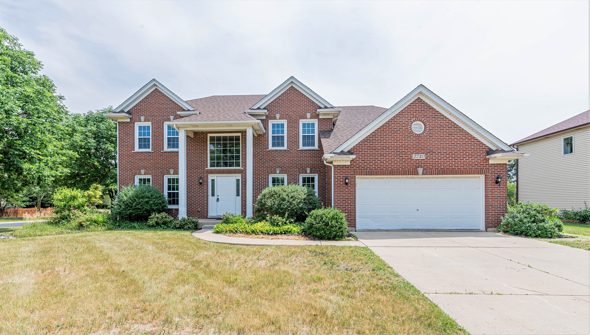 2740 Fairhauser Road Naperville, IL 60564 - Photo 2 of 2 a front view of a house with a yard and garage